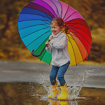 Little girl with colourful umbrella